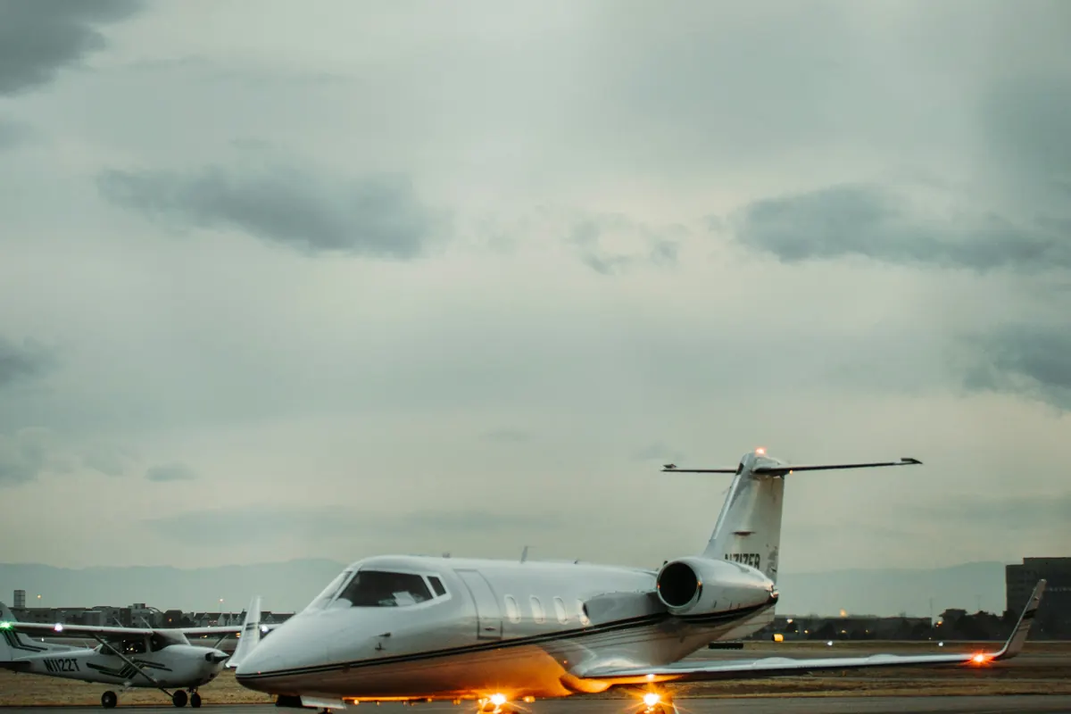 Business jet taxiing toward the camera under a cloudy sky